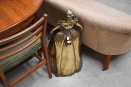 A Victorian brass fire guard in the form of Marie Antoinette or crinoline lady