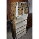 An interestering industrial/commercial shelf unit with upper cupboard, having vintage newspaper