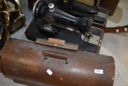 A vintage singer sewing machine (electric) in oak case , wiring removed for safety