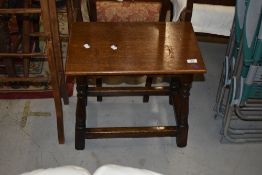 A reproduction coffin stool occasional table