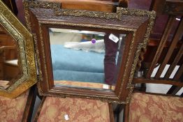 A late Victorian hall way mirror having ornate frame with bevel edged glass