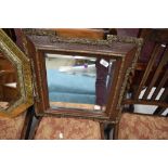 A late Victorian hall way mirror having ornate frame with bevel edged glass