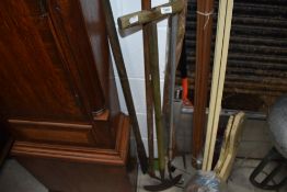 A selection of gardening tools including fork, edger and hoe