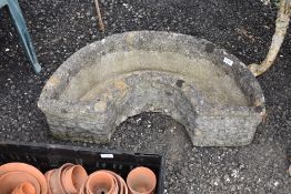 a modern composite concrete half circle trough