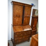 A late 18th century secretaire book case having walnut veneer frontage with original brass handles