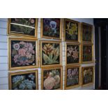 A set of twelve framed floral tapestry works, in gilt frames