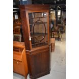 An early 20th Century mahogany corner display with lower cupboard section