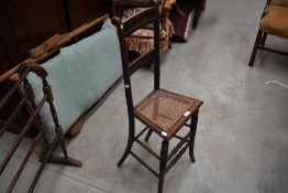 An unusual Victorian bend and turned wood frame child or maids chair with rattan seat