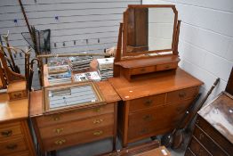 An arts and crafts made dressing table in light oak with a similar chest of three drawers