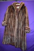 A full length fur coat having Marshall and Snelgrove,Southport label.