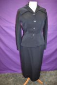 A 1940s navy skirt suit, single breasted with buttons to front and two pockets, 'Robell,London'