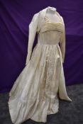 A full skirted 1950s cream brocade wedding dress and bolero.