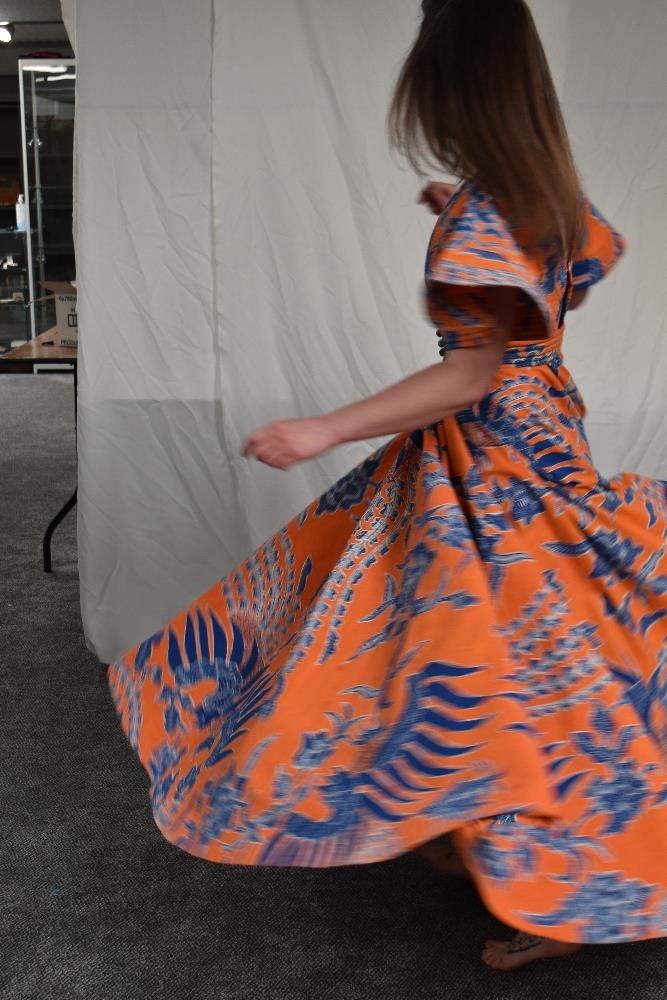 A vintage Batik evening dress having orange ground with bold blue and white design, Made in - Image 8 of 9