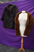 A dark brown fur jacket and a mink wrap,both around 1950s.