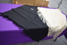 Two antique fringed shawls,wool or wool blend,one cream the other black.