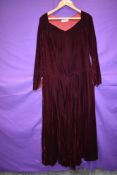 A late 1930s Harvey Nichols burgundy velvet dress having brass zip to side and slight drop waist,
