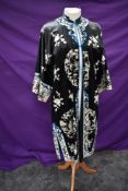 An early 1900s Silk dressing gown having extensive embroidery to front and reverse, also in silk,