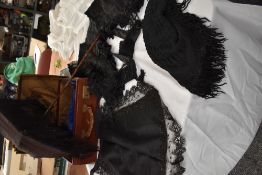 A suitcase containing a selection of Victorian items to include, black silk parasol,beaded apron,