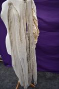 A distressed/deconstructed early 20th century dress having a good amount of beads and fabric to be