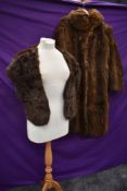 A full length fur coat, around 1930s and a 1950s Coney stole with pockets to ends.