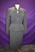 A 1940s sgrey skirt suit, single breasted with buttons to front and four pockets, 'Robell,London'