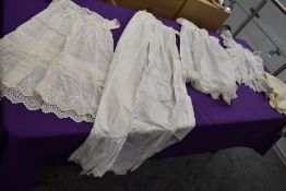 A selection of antique babies clothing including shawl and dresses with intricate Broderie Anglais