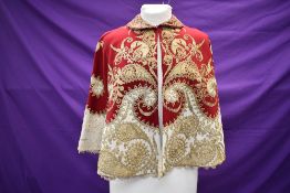 An early 1900s incredibly decadent red and cream wool shawl lined in cream silk having incredibly