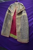 An unusual quilted cape using vibrant colours, appears to be early 20th century,having gauze like