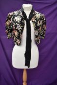 A 1930s floral embroidered crepe bolero or short jacket with pussy bow to neck.