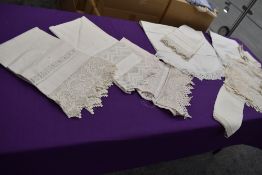 A collection of antique linens, including deeply crotchet items.