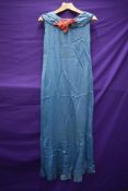 A 1930s blue evening gown having boat neckline, no fastening,smaller size.