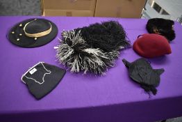 A mixed collection of items including vintage and antique hats, a Victorian bag/purse and a black