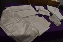 An assortment of antique linen including damask table cloths and bed sheet, and deep crotchet