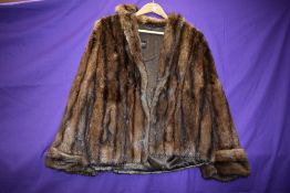 A short fur jacket,soft long pelt with longer guard hairs in a rich mahogany tone.