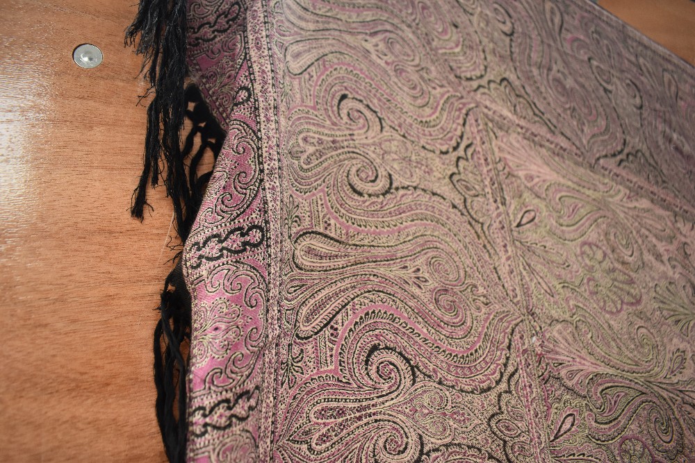 A circa 1970s crinoline shawl having paisley printed pattern in dark pink and black with fringed - Image 2 of 3