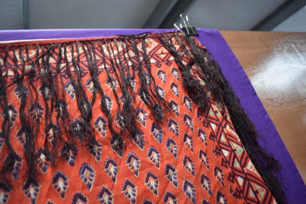 A Circa 1900s red silk shawl having deep fringing and green,burgundy and purple pattern. - Image 2 of 3