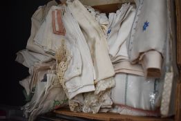 A large box of vintage and antique table linen including some in original packaging, embroidered