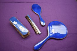 An electric blue guilloche dressing table set, comprising of mirror,brush, comb and smaller mirror