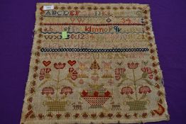 A Victorian sampler dated 1856, By Eliza Wrigglesworth, aged 10 with a variety of pictures including