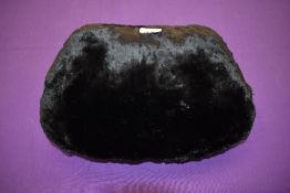 A late 19th/early 20th century mole skin or similar fur muff lined with white coney.