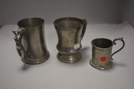 A Manor Pewter tankard with female nude form handle, sold together with two other pewter items.