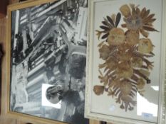 An aerial photograph of a mill or factory with dried foliage framed