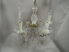 A five branch candelabra having cut glass arms with lustre droplets