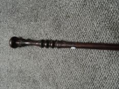 An ethnic hard wood carved walking stick or cane with knopped handle