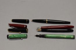Four fountain pens including Parker 45, Slimfold (engraved) and two Platignum leverfill one red