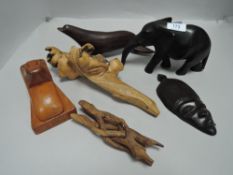 A selection of hard wood carved animals including seal elephant and lizard