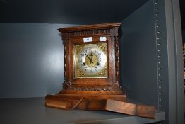 An antique bracket clock having oak casing with brass and steel clock face