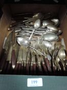 A selection of cutlery and flatware including teak and brass handled set