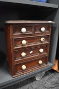 A small 20th century specimen style or apprentice chest of drawers of two over three