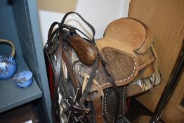 An American style leather tooled and carved horse saddle sheep skin lined with bridal, American